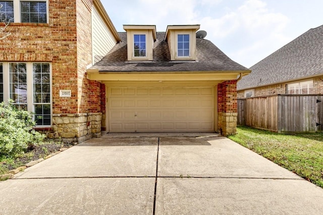 garage with driveway and fence