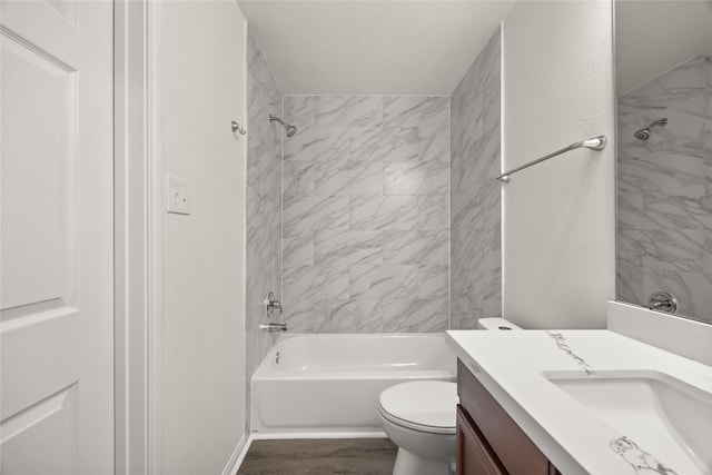 full bath with toilet, tub / shower combination, vanity, and wood finished floors