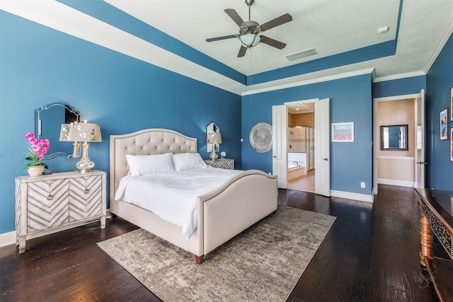 bedroom featuring visible vents, a raised ceiling, baseboards, and hardwood / wood-style flooring