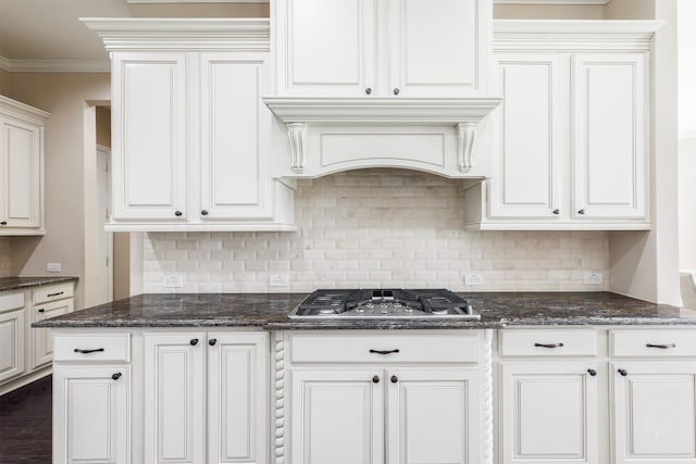 kitchen featuring backsplash, ornamental molding, white cabinetry, and stainless steel gas stovetop