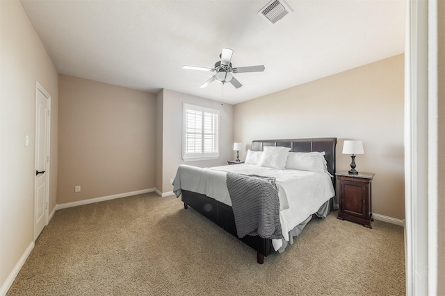 bedroom featuring ceiling fan, baseboards, visible vents, and light carpet