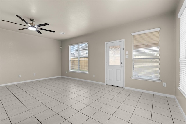 foyer entrance with visible vents, baseboards, and a ceiling fan