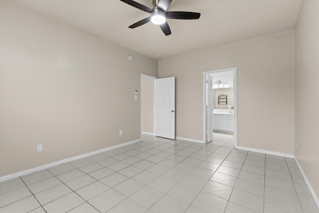 empty room featuring light tile patterned floors, baseboards, and a ceiling fan