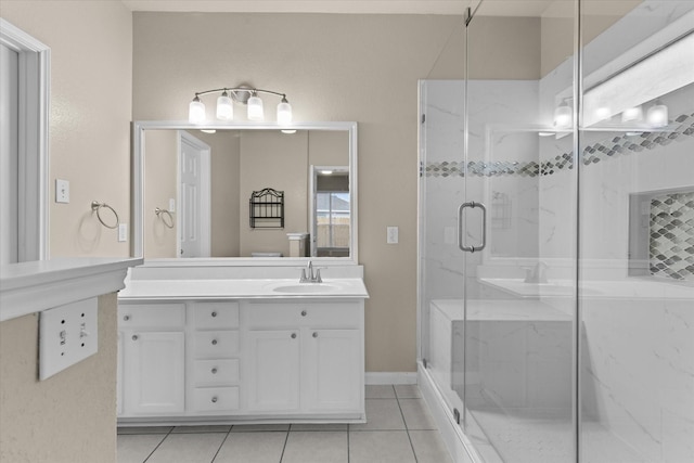 bathroom with vanity, tile patterned flooring, and a marble finish shower