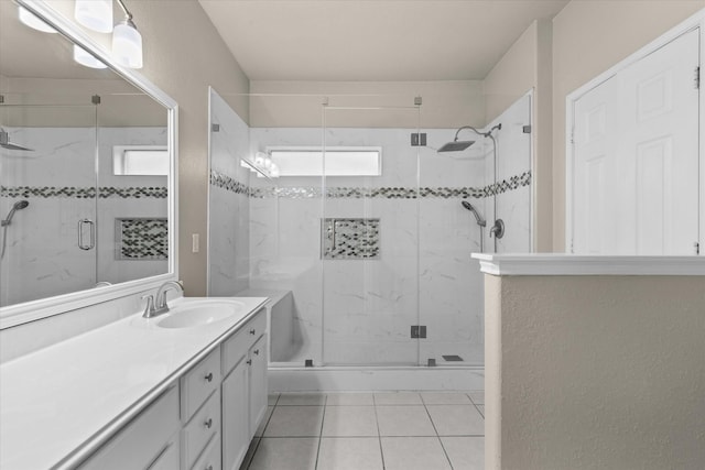 bathroom featuring vanity, tile patterned floors, and a stall shower