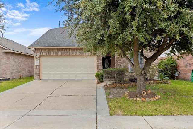 view of front of property with brick siding, concrete driveway, roof with shingles, a front yard, and an attached garage