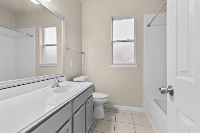 bathroom featuring tile patterned flooring, toilet, plenty of natural light, and vanity