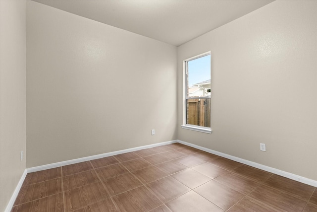 unfurnished room featuring baseboards