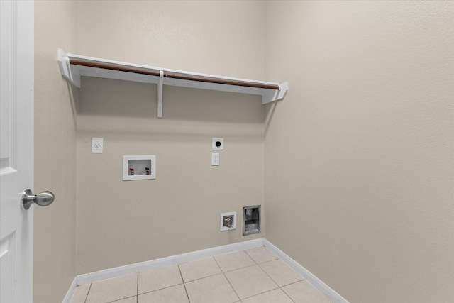 laundry area featuring hookup for a washing machine, baseboards, laundry area, light tile patterned flooring, and electric dryer hookup