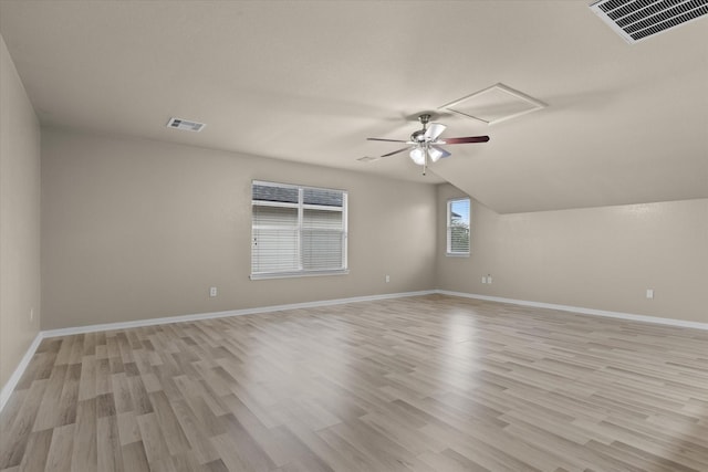 interior space featuring visible vents, baseboards, ceiling fan, and light wood finished floors