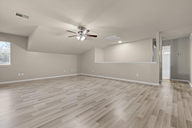 additional living space featuring vaulted ceiling, visible vents, and light wood-type flooring