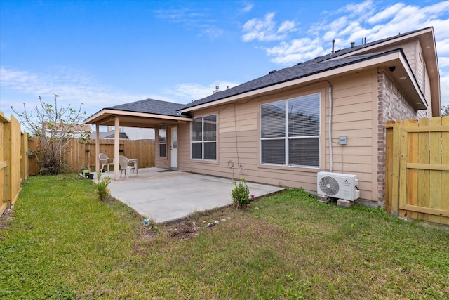 rear view of property with ac unit, a lawn, a fenced backyard, and a patio area