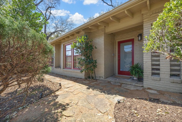 property entrance with brick siding