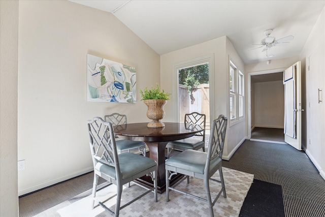 dining space featuring baseboards, lofted ceiling, and a ceiling fan