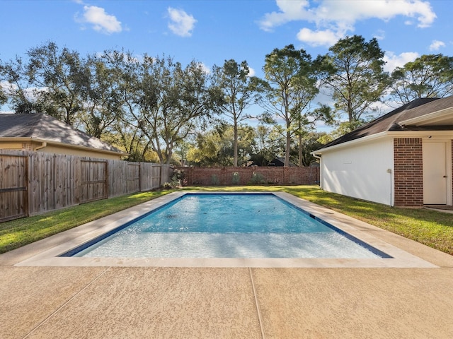 view of swimming pool with a yard, a fenced in pool, a patio, and a fenced backyard