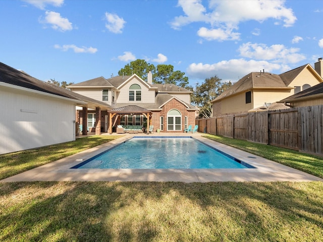 view of swimming pool featuring a fenced backyard, a gazebo, a yard, a fenced in pool, and a patio area