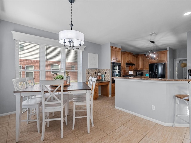 dining area featuring plenty of natural light, baseboards, light tile patterned floors, and a chandelier