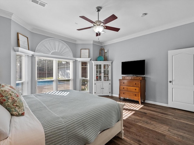 bedroom with visible vents, crown molding, ceiling fan, baseboards, and wood finished floors