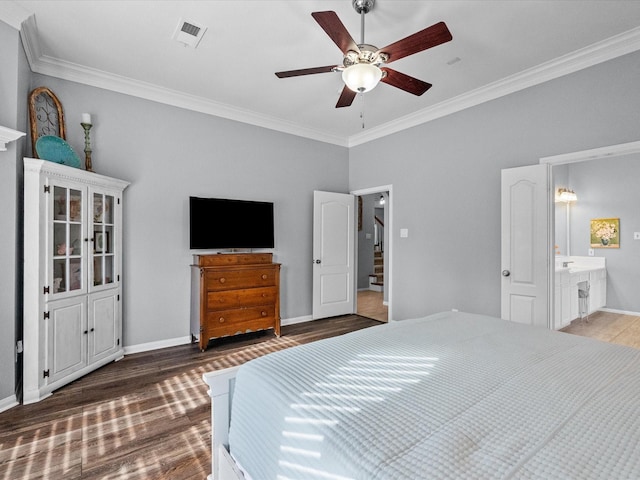 bedroom with crown molding, wood finished floors, visible vents, and baseboards