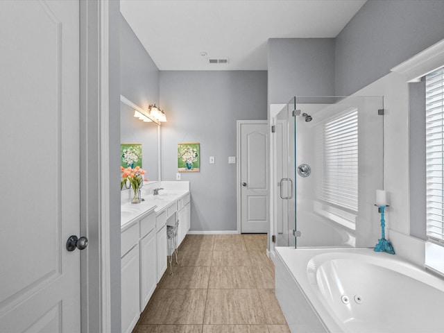 bathroom with visible vents, a shower stall, a whirlpool tub, double vanity, and a sink