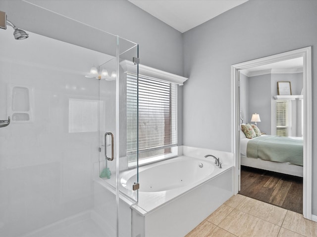 full bath featuring tile patterned floors, a tub with jets, a stall shower, and ensuite bathroom