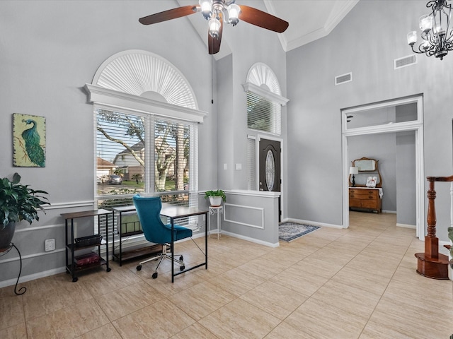 office area featuring visible vents, baseboards, ornamental molding, ceiling fan with notable chandelier, and a towering ceiling