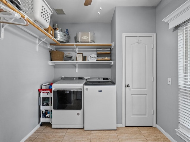 laundry area featuring a ceiling fan, washer and clothes dryer, light tile patterned floors, baseboards, and laundry area