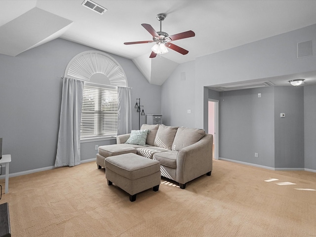 living area with light carpet, visible vents, attic access, and a ceiling fan