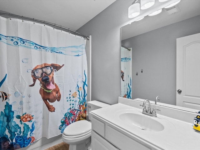 full bathroom featuring vanity, toilet, and visible vents