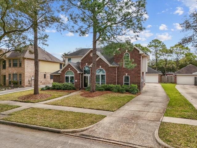 traditional-style house featuring brick siding, a front lawn, and fence