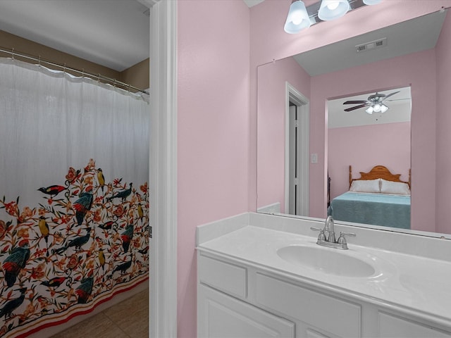 ensuite bathroom featuring vanity, ensuite bath, a ceiling fan, and visible vents