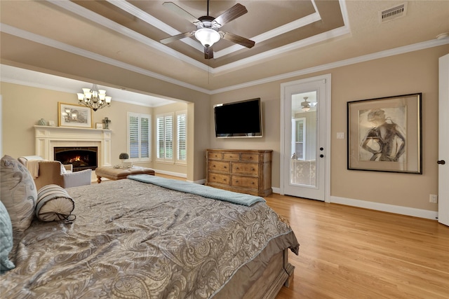 2814 S Cotswold Manor Dr, Kingwood, TX 77339 - bedroom featuring visible vents, a raised ceiling, light wood-style floors, and crown molding