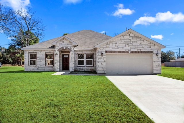 french country home with a front lawn, an attached garage, stone siding, and driveway