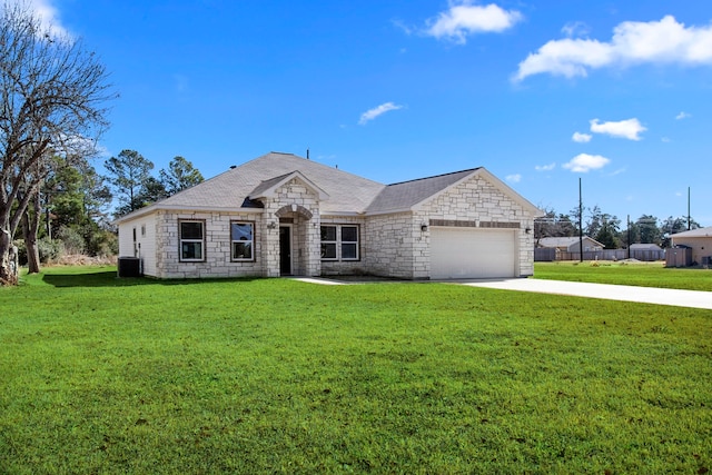 french provincial home featuring stone siding, an attached garage, driveway, and a front lawn