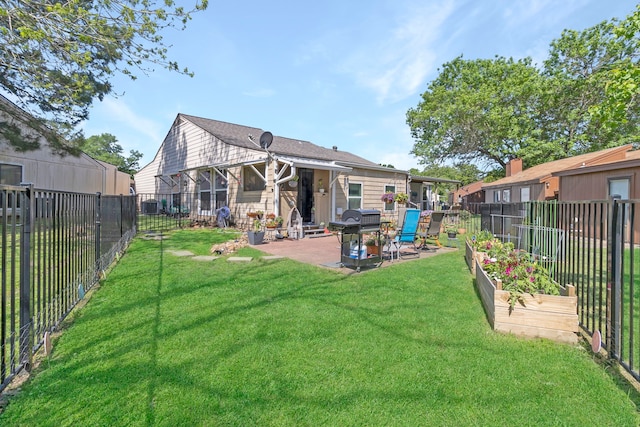 back of house with a fenced backyard, a yard, and a patio area