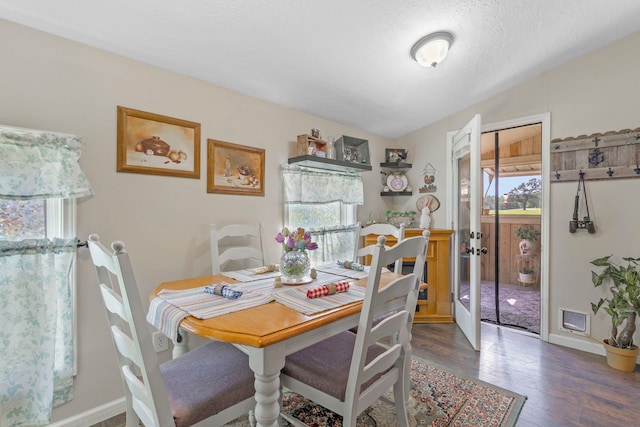 dining area with dark wood-style floors, visible vents, french doors, and baseboards