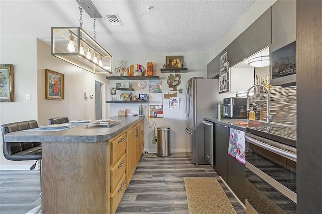 kitchen with visible vents, open shelves, a textured ceiling, and appliances with stainless steel finishes
