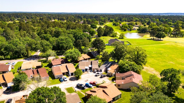 aerial view with a forest view, a residential view, a water view, and view of golf course