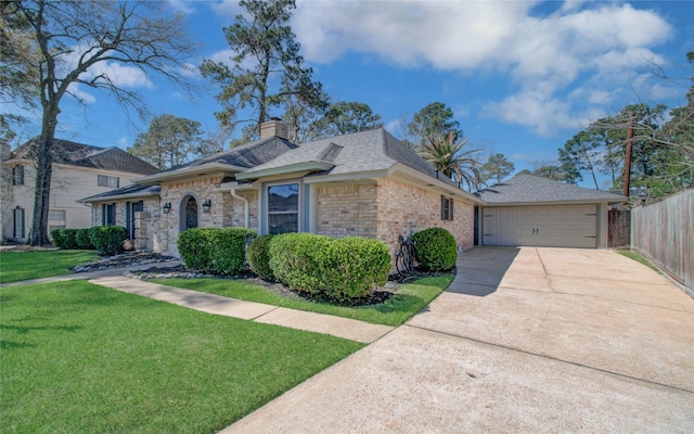 view of front of property featuring a front yard, fence, a chimney, concrete driveway, and a garage