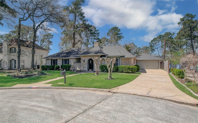 view of front facade featuring a front yard, a garage, driveway, and a chimney