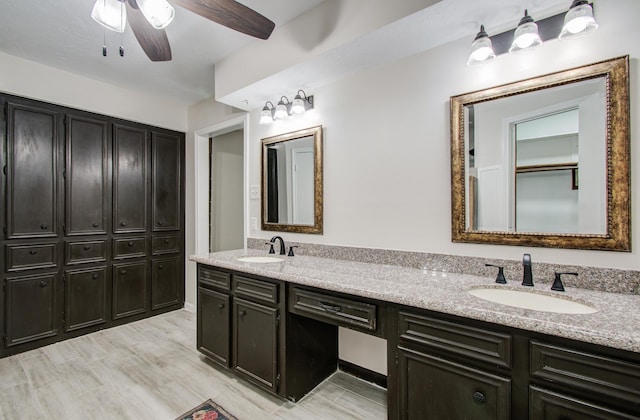 full bathroom featuring double vanity, a ceiling fan, and a sink