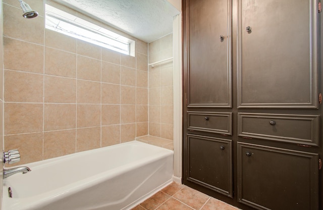 bathroom featuring tile patterned flooring, a textured ceiling, and shower / bath combination