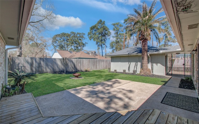 wooden terrace with a patio, a yard, and a fenced backyard