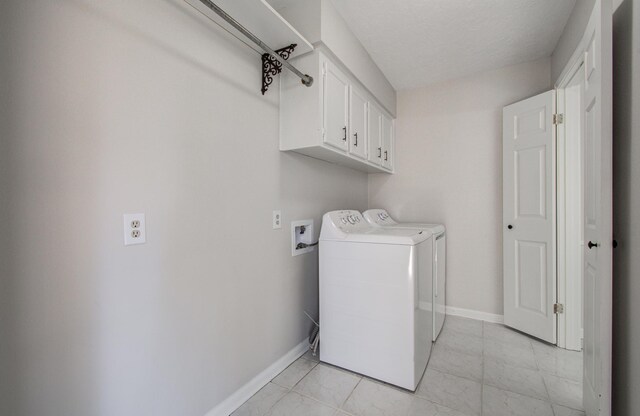 laundry area featuring cabinet space, independent washer and dryer, and baseboards