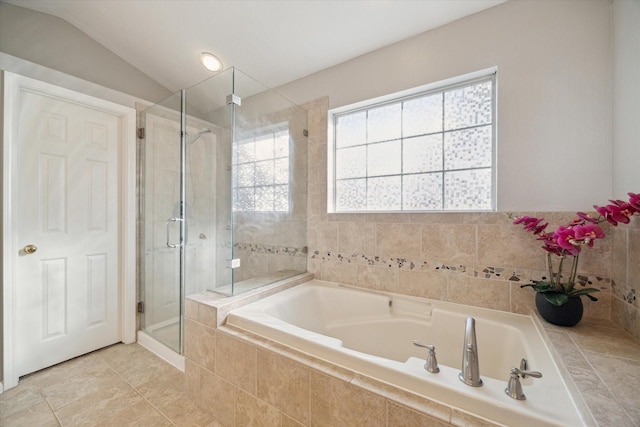 bathroom with a wealth of natural light, lofted ceiling, a stall shower, and a bath