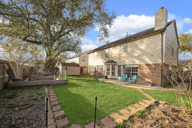 back of house featuring a garden, a fenced backyard, an outdoor structure, a storage shed, and a lawn