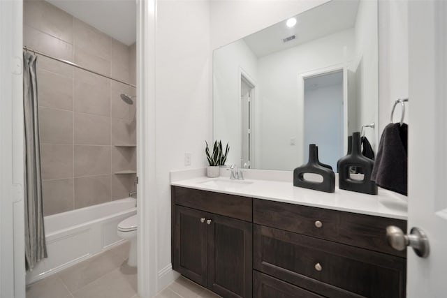 bathroom with vanity, visible vents, tile patterned floors, toilet, and shower / tub combo with curtain