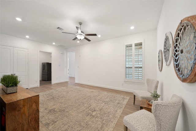 sitting room with visible vents, recessed lighting, light wood-type flooring, and ceiling fan