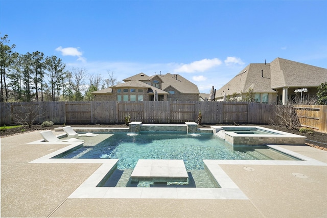 view of pool featuring a pool with connected hot tub and a fenced backyard