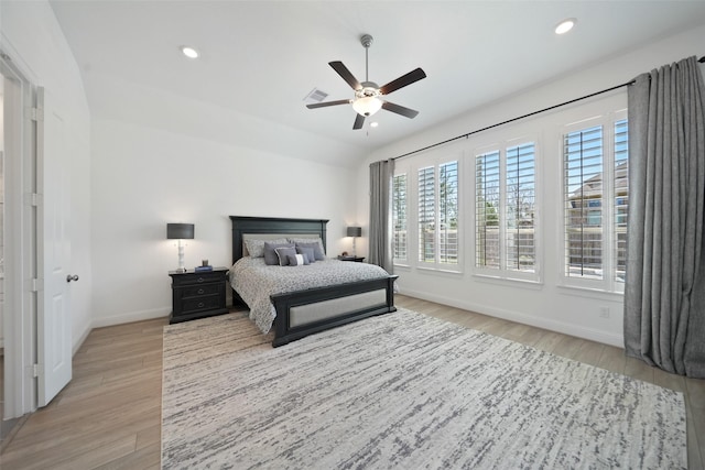 bedroom featuring a ceiling fan, visible vents, baseboards, recessed lighting, and light wood-style floors